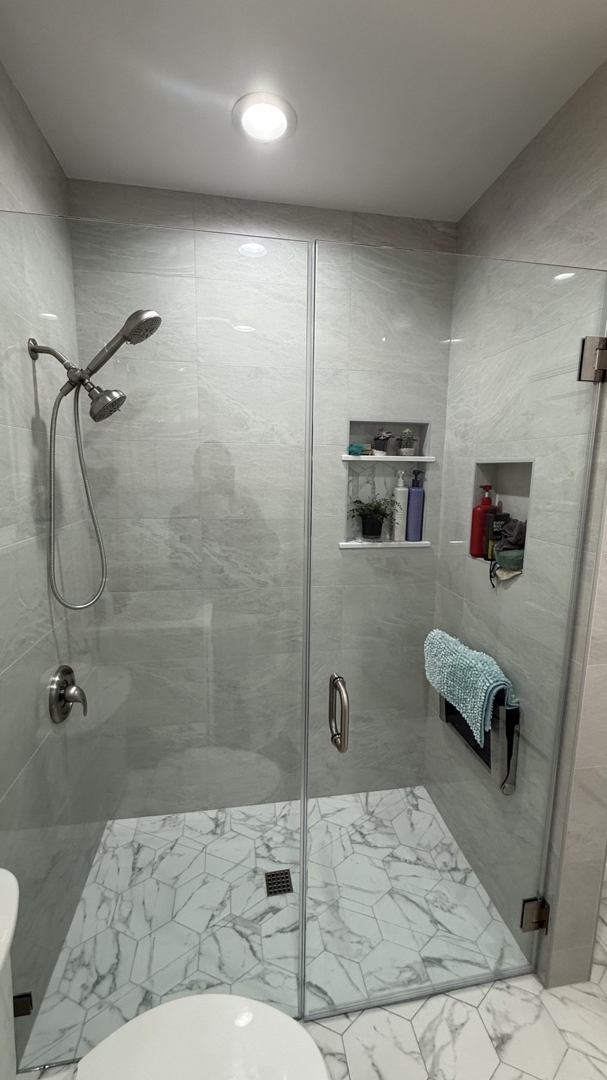Completed ARC bathroom remodel: glass shower enclosure and tile details